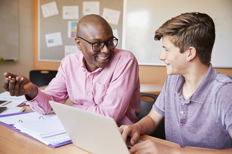 Black male counselor white male student iStock
